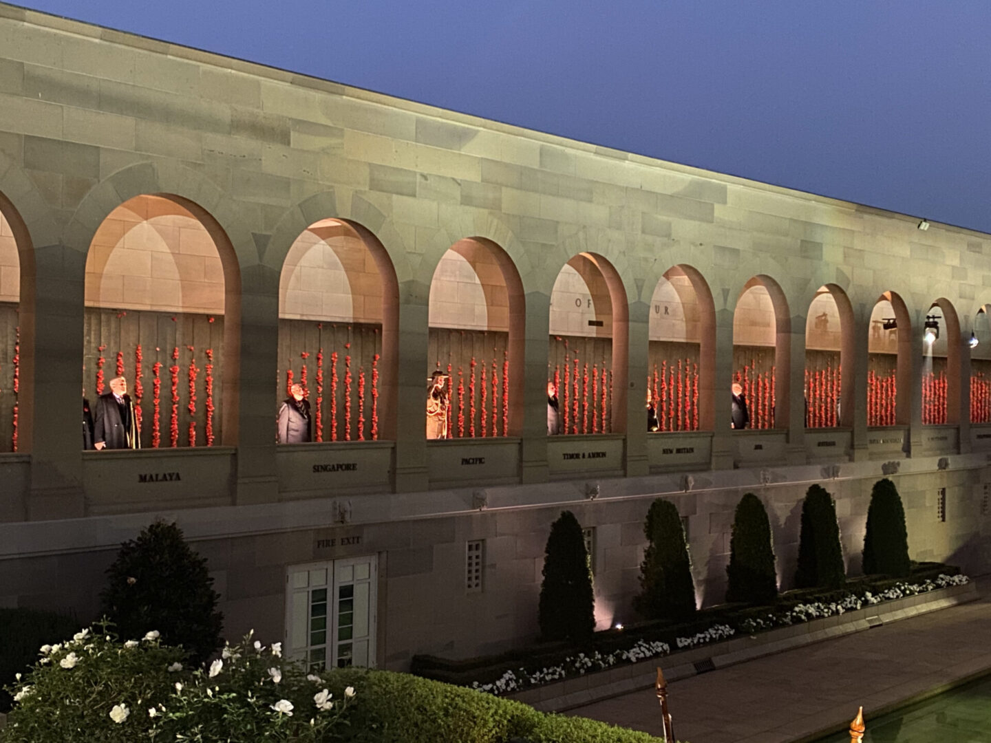 A building with arches and a bunch of organ pipes
