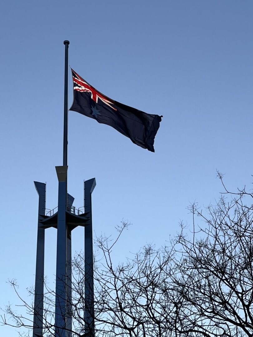 A flag flying on top of a metal pole.