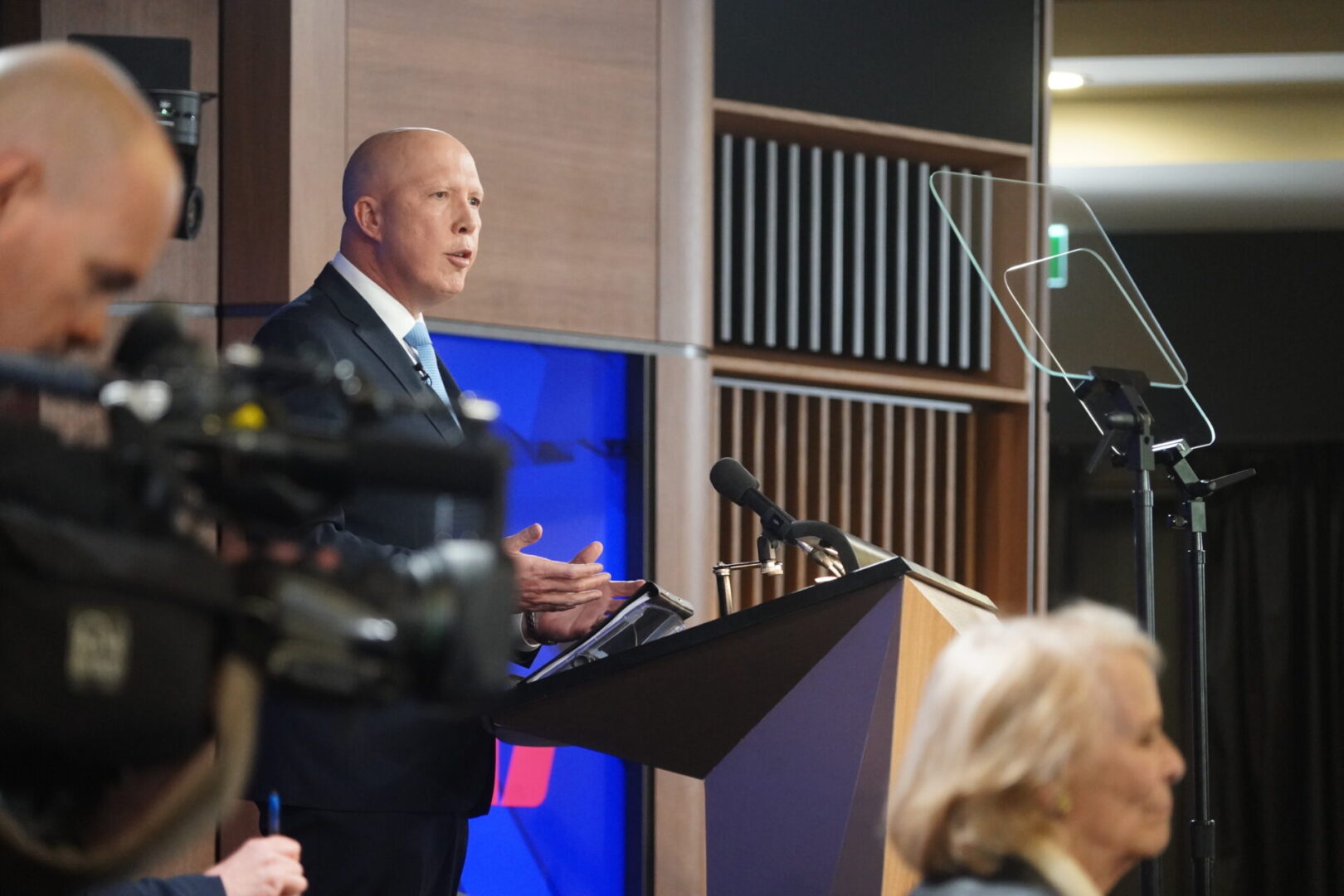 A man standing at a podium in front of a microphone.
