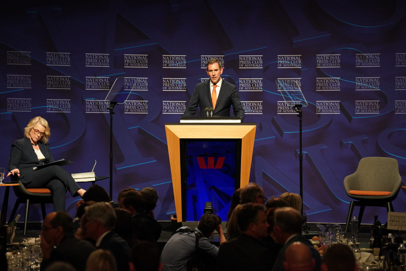A man standing at the top of a podium.