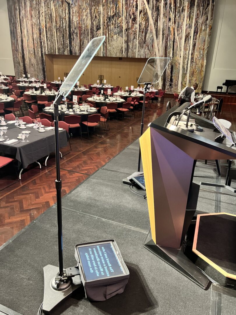 A microphone and podium in an empty room.
