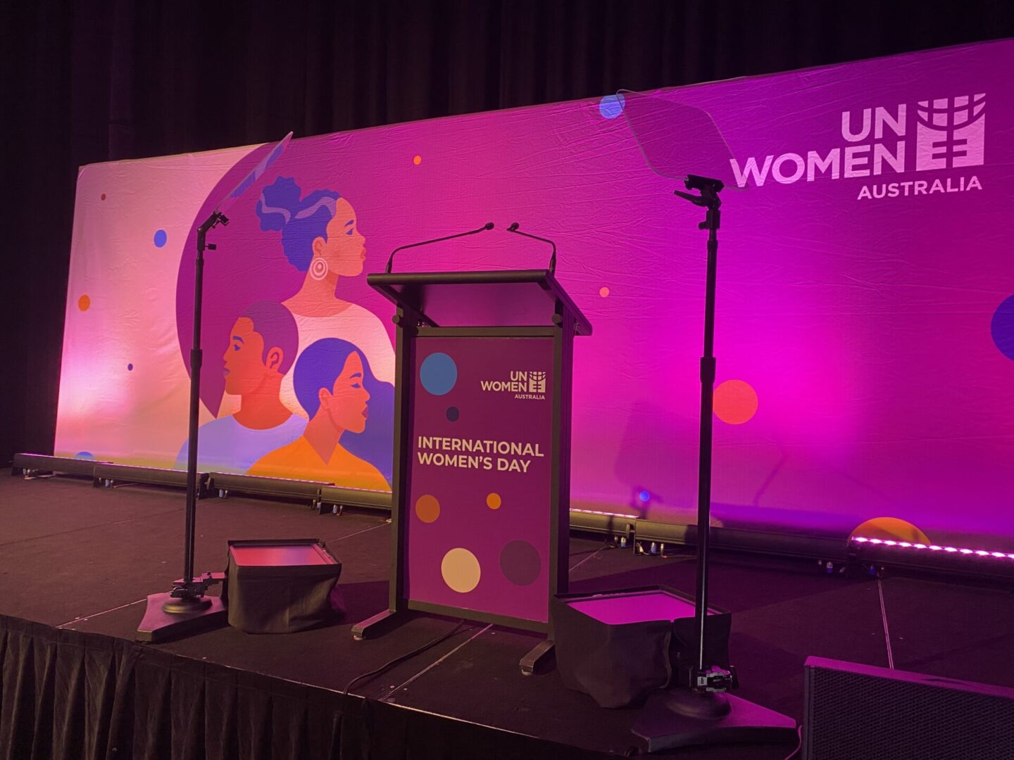 A podium with microphones and speakers on it.